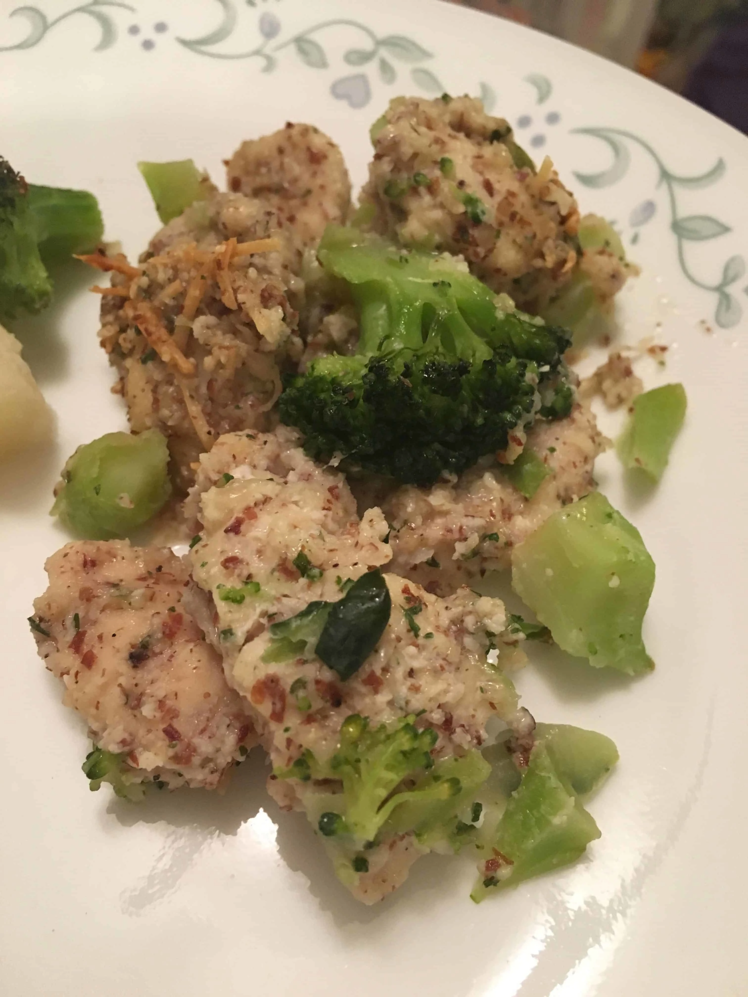 A plate of food with broccoli, with keto almond parmesan Chicken