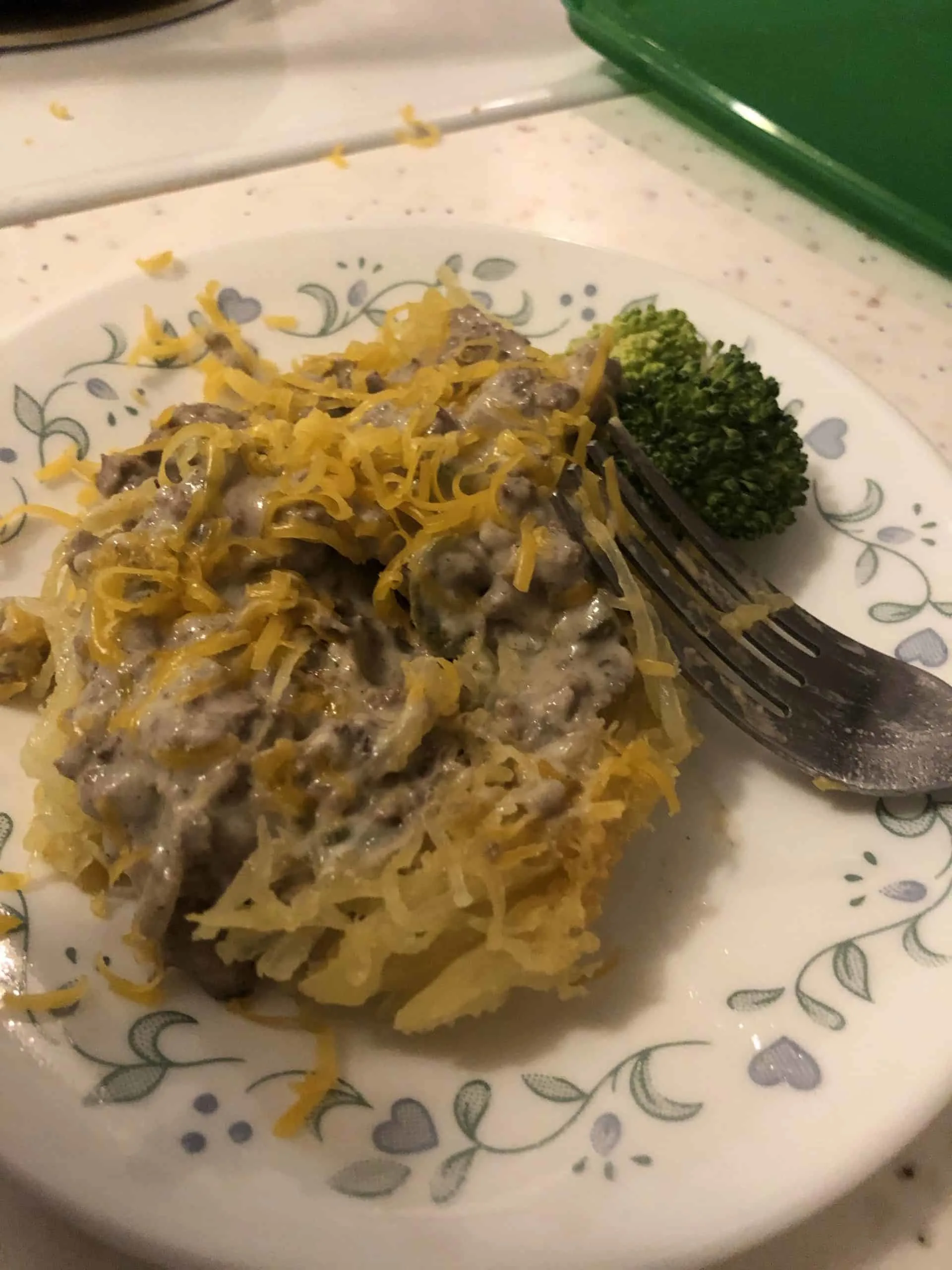 A plate of low carb stroganoff over spaghetti squash with broccoli and a fork