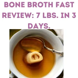 bowl of bone broth soup with a single beef bone in the center next to the spoon