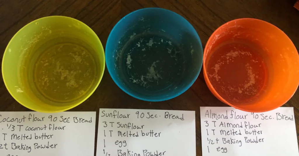 3 empty bowls with 3 recipes underneath them. first recipe is for coconut flour 90 second bread. second is sunflour 90 second bread, third is almond flour 90 second bread
