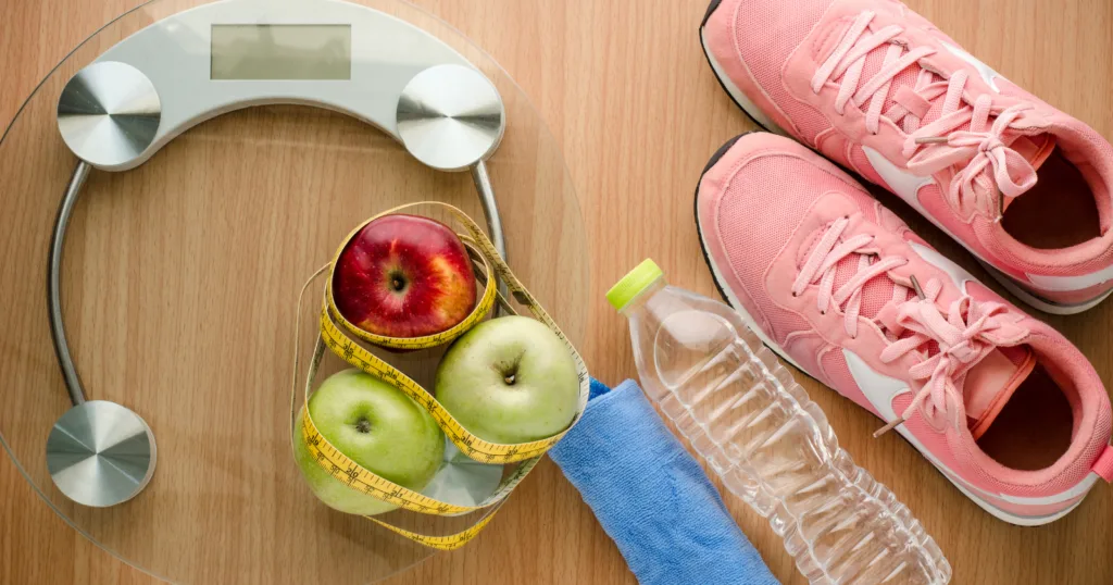 everything you need for a healthy workout: scale, fibrous apples, water bottles and good running shoes